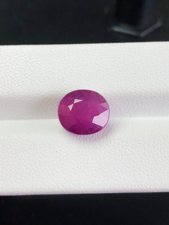 Faceted purple gemstone on a white background