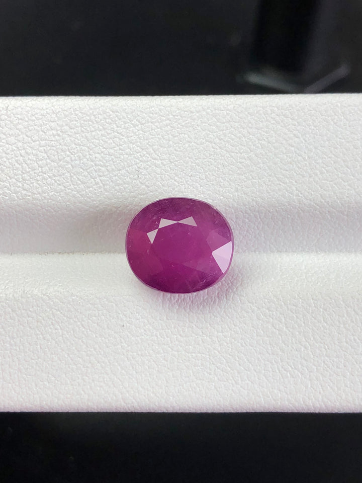 Faceted purple gemstone on a white background